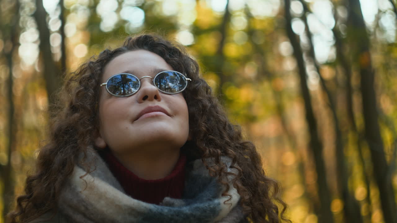Woman with Curly Hair in Autumn Forest