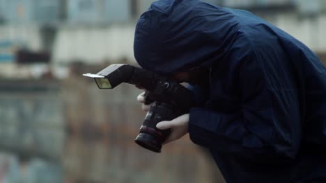 forensic detective photographing killed person, side view closeup