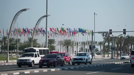 city street traffic with international flags and palm trees