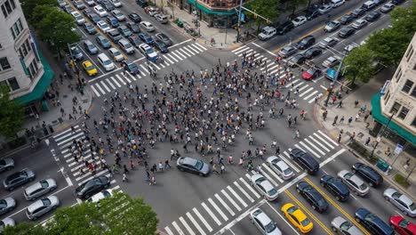 busy city intersection with pedestrians and traffic from aerial view