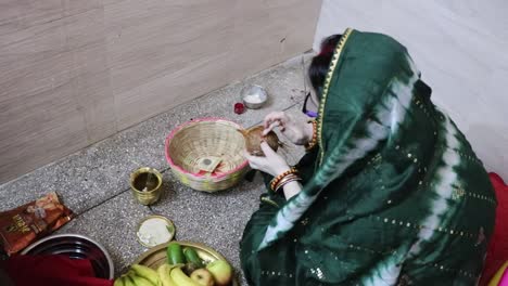 indian women doing holy rituals at home for children's wellbeing from different angle on the occasion of jitiya vrat or nirjala vrat in india