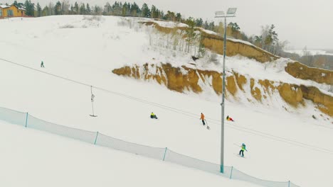 beginner skiers track and t-bar lift on hill aerial view