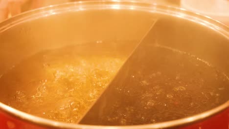 simmering hot pot with two broth sections