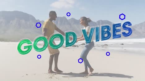 animación de las palabras buenas vibraciones en azul sobre una pareja feliz bailando en la playa
