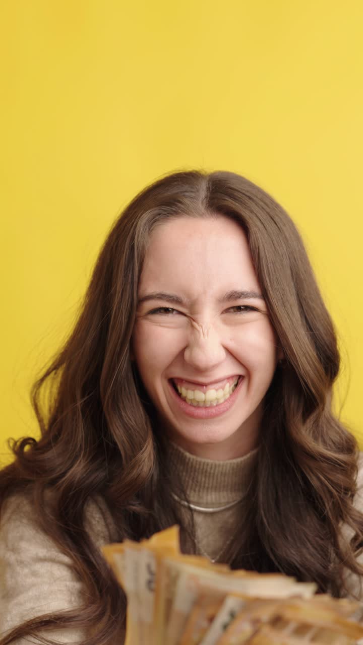 Excited woman celebrating success with euro banknotes