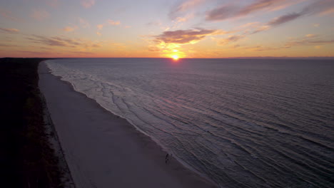 golden sunset aerial view orbiting across krynica morska on the baltic sea in poland
