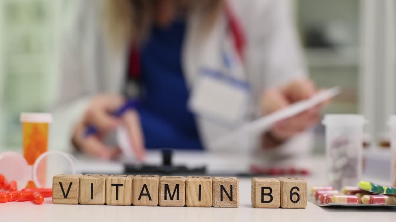 Vitamin B6 Supplement on a Desk with a Doctor in the Background