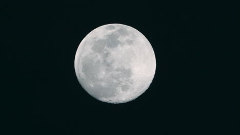 A-shot-of-a-full-moon-slowly-rising-in-the-sky-in-Tokyo,-Japan