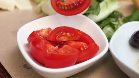 close up of sliced tomatoes in a white bowl