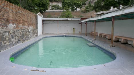 abandoned hot spring pool at tubiak, lake toba, with a tranquil, desolate feel