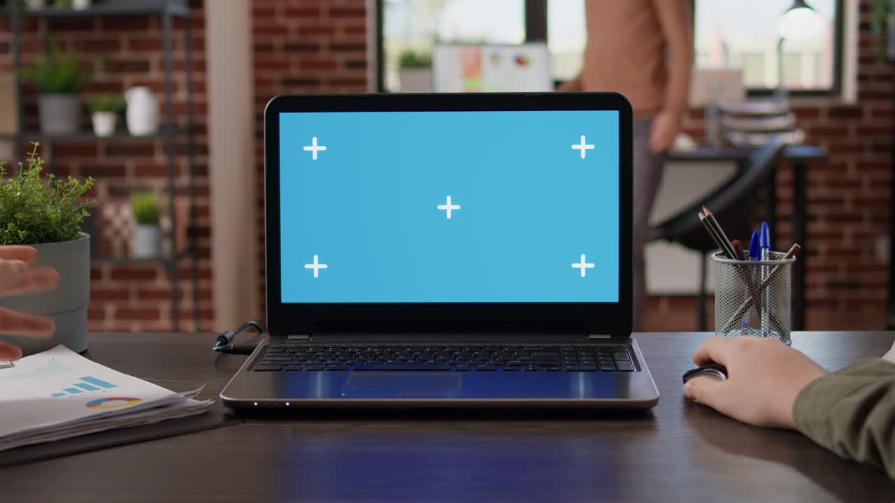 POV of startup manager typing on laptop with greenscreen