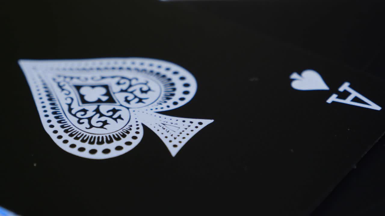 Macro shot of the ace of spades of a black deck of cards