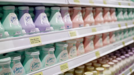 rows of pastel-colored bottles on supermarket shelves