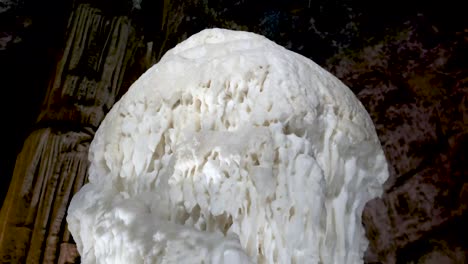 Postojna-caves-interior-pan-over-stalagmites-stalactites