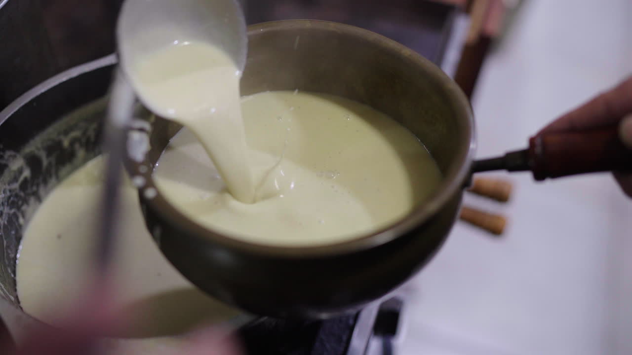 Close-up of Creamy Argentine Bagna Cauda poured into rustic bowl, authentic cooking and heritage tradition
