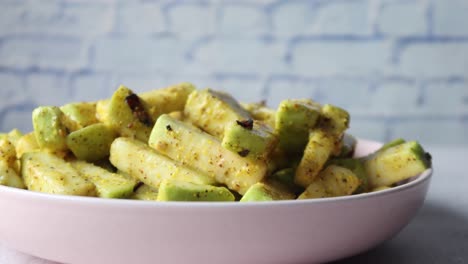 spicy green vegetable pickle in pink bowl