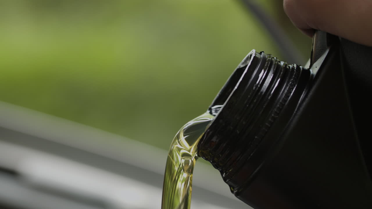 Close-up of motor oil being poured