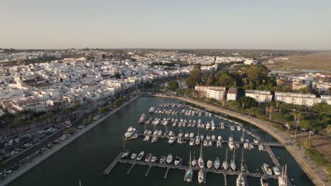 Aerial-pullback-Ayamonte-marina-reveal-Coastal-Spanish-village,-white-house-Landscape