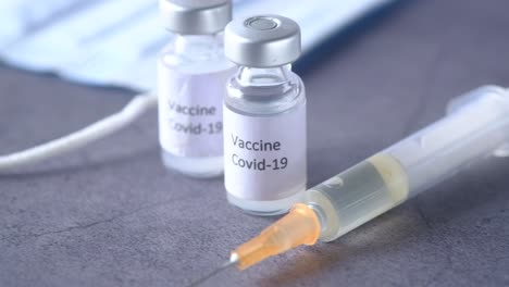 covid-19 vaccine, syringe, and medical supplies