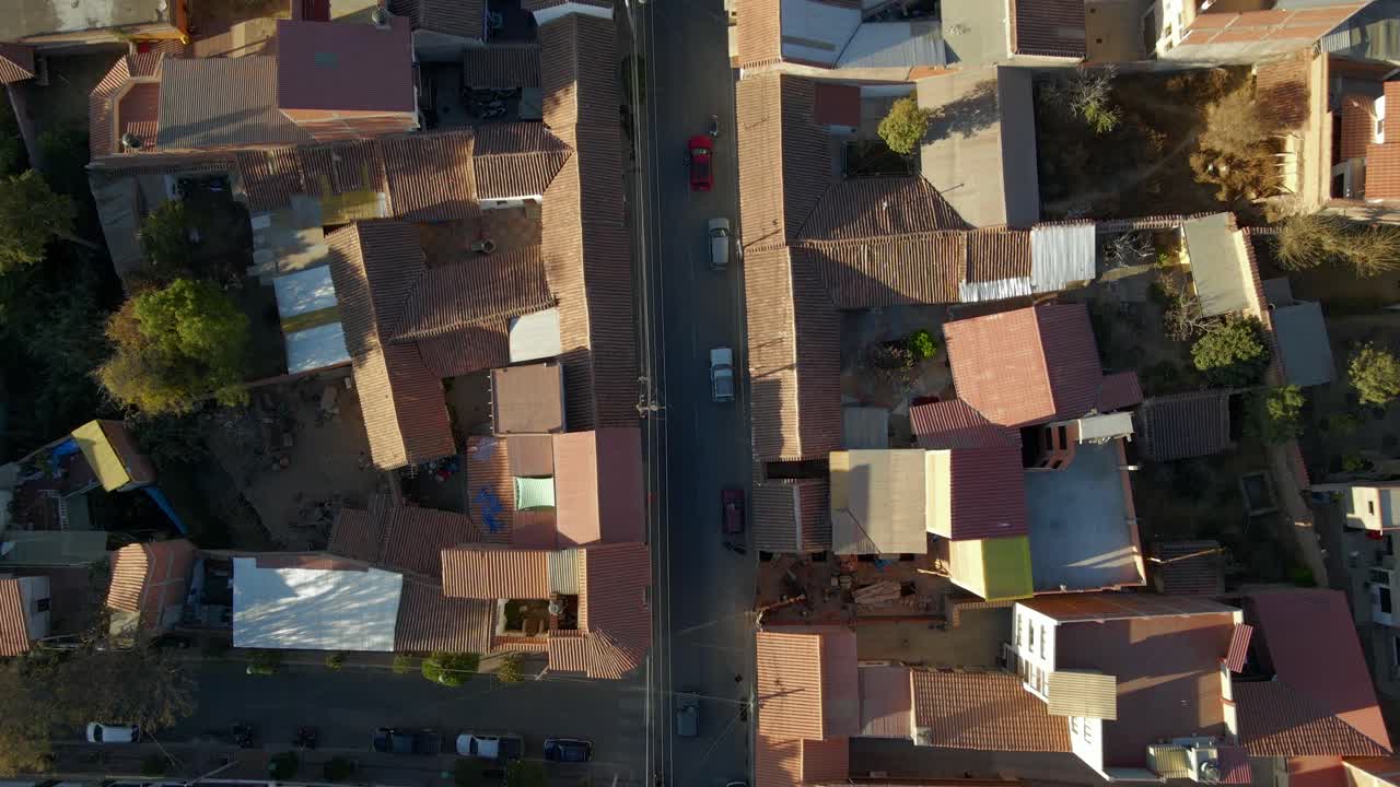 Tight drone aerial over Sucre showing densely packed rooftops and street structure