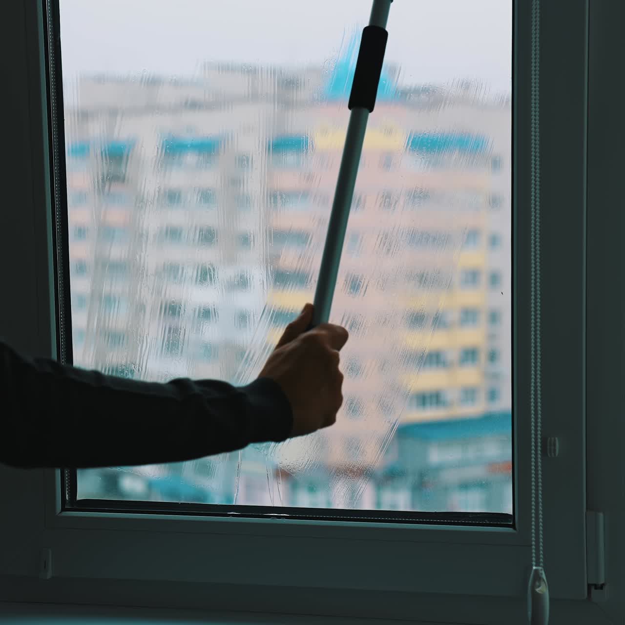 Window cleaning with water and devices. Glass cleaner working with wet windows