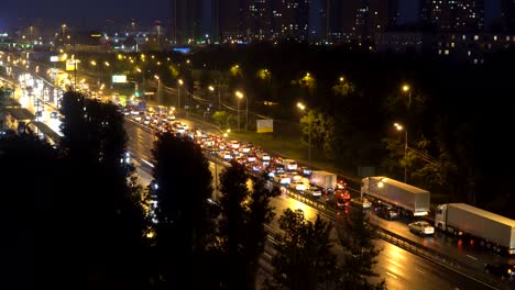 night panoramic view of traffic and windows of houses on the outskirts of the metropolis,