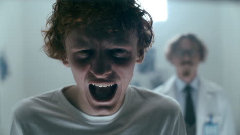 portrait of patient crying and screaming in agony at psychiatric hospital