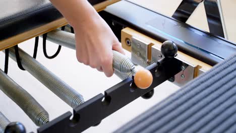 Woman-using-exercising-equipment-at-fitness-studio-4k