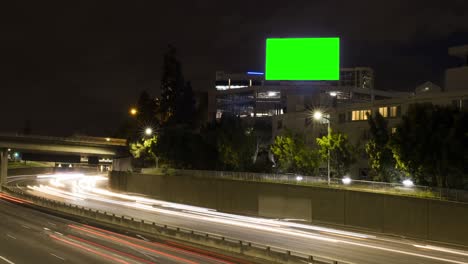 city street billboard stand with green screen. time lapse, cars on highway
