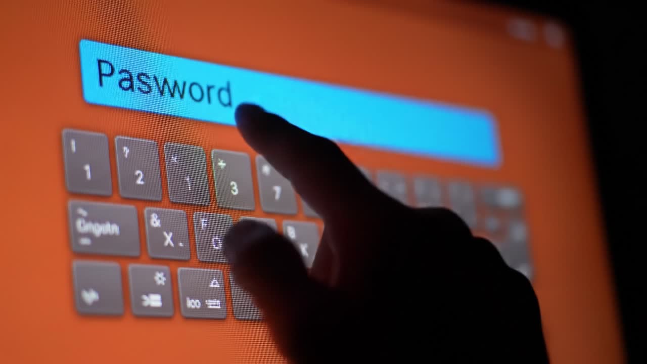 A hand is seen carefully typing a password on a virtual keyboard displayed on a touchscreen device. The vibrant orange background enhances the focus on security and digital access.
