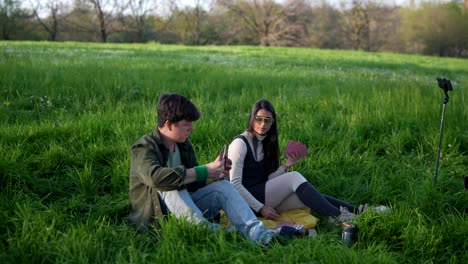 couple playing cards in a park
