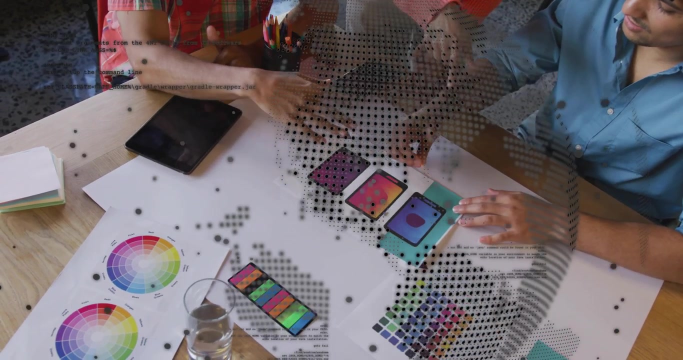 Design team tapping and aligning mockups with swatches for design review under dotted globe overlay