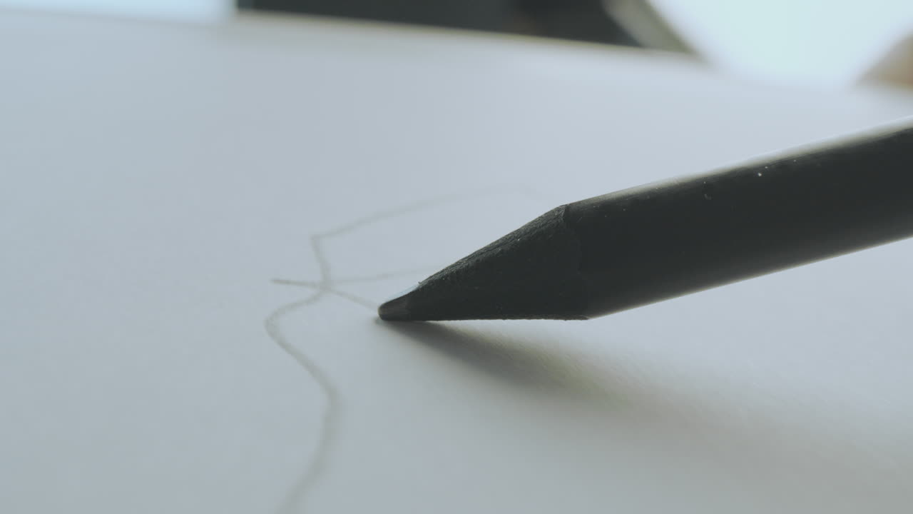 Close-up of a pencil sketching on paper