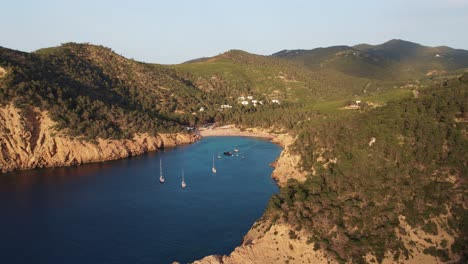 aerial view of cala benirras beach lit by sunset light in ibiza