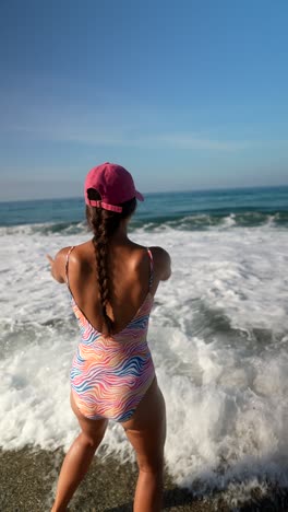 woman in swimsuit posing on the beach