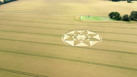 Aerial-view-circling-towards-Micheldever-geometric-star-crop-circle-on-Hampshire-golden-wheat-field-2023