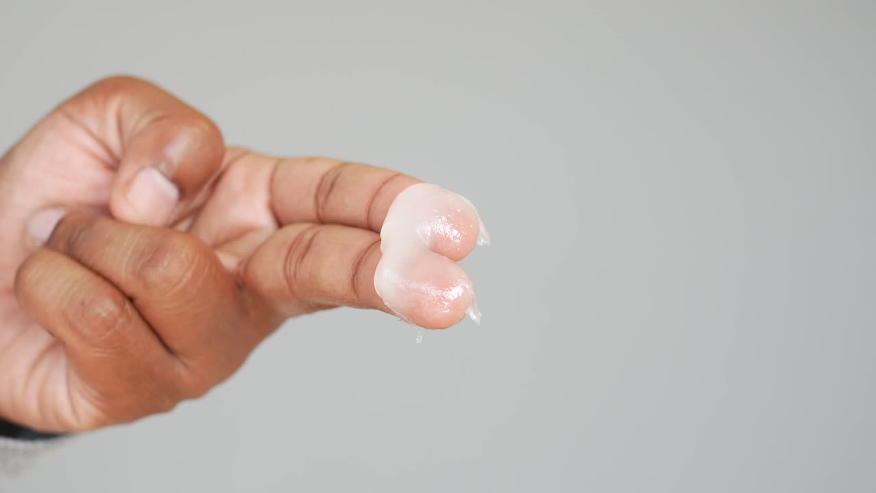 Hand applying cream or lotion.