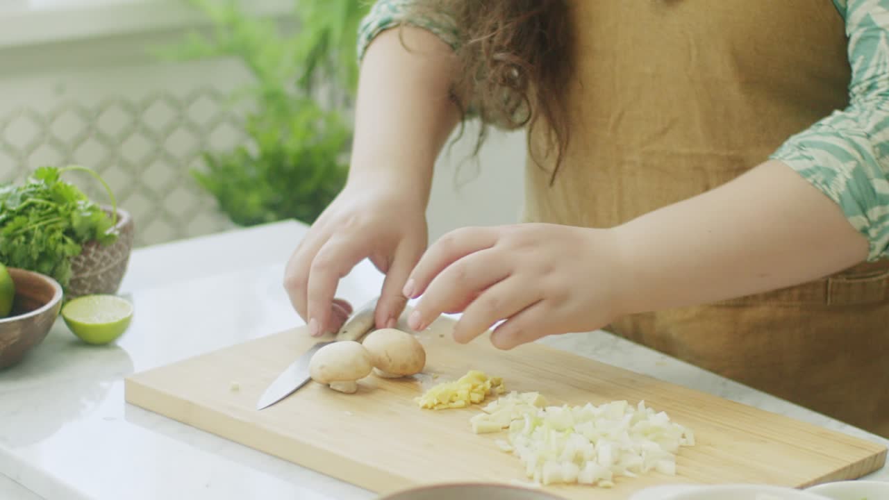 Woman cutting ingredients on chopping board for meal