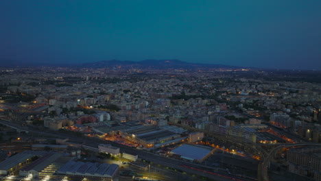 Aerial-panoramic-footage-of-large-city-in-evening.-Apartment-houses-in-residential-urban-boroughs.-Rome,-Italy