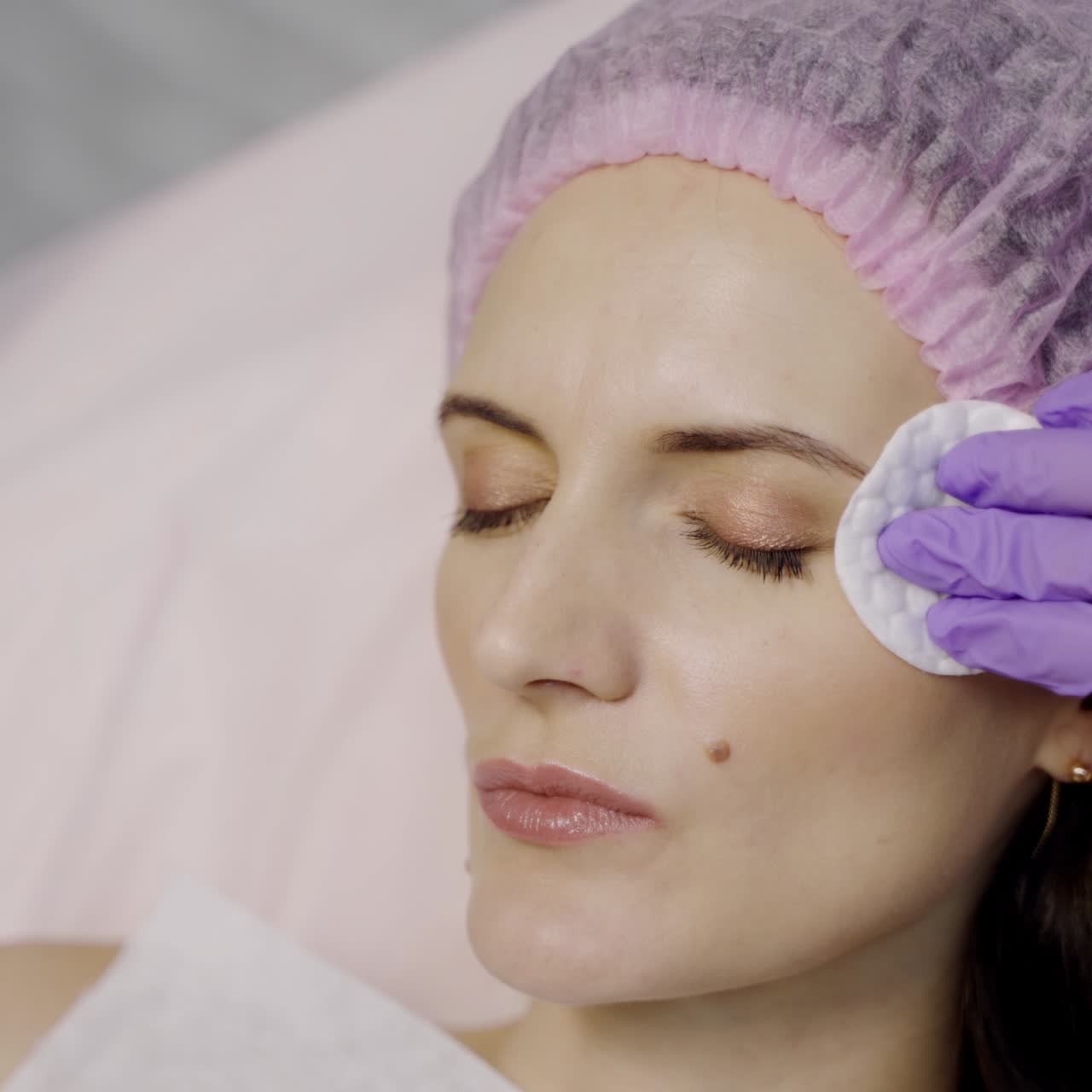 A cosmetologist injects Botox shots into the wrinkle area of a beauty woman. Prevention of crow's feet. Modern cosmetology