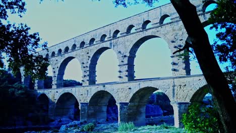 roman aqueduct pont le gart in france between trees