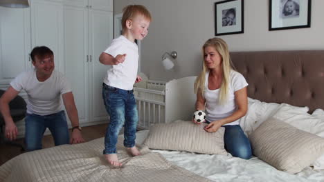 padres divirtiéndose con su hija pequeña en la cama. familia pasando el tiempo por la mañana