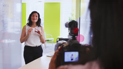 camerawoman and businesswoman making instructional video