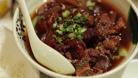 savoring a flavorful beef noodle soup bowl