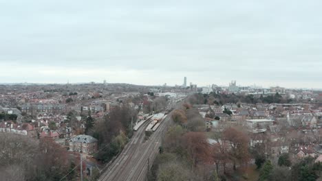 Dolly-forward-drone-shot-over-Hanwell-TfL-rail-station-west-London