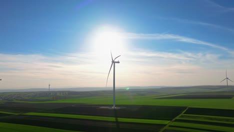 wind turbines on a sunny day in a vast green field