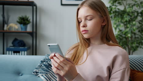 teenage girl using smartphone at home