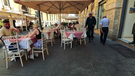 people enjoying a meal at a street cafe