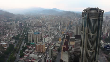 4k aerial view of one of the central park towers in the city center, as well as view of the valle-coche highway and much of western caracas, venezuela