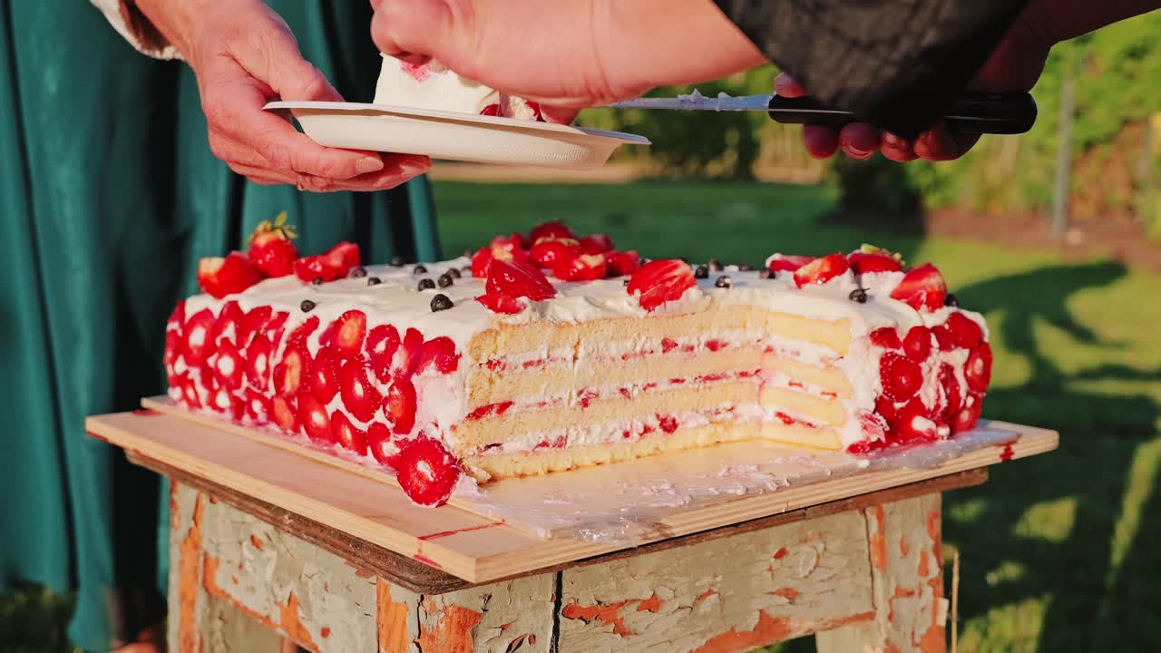 Strawberry cake plated in golden light during sunset, captured in slow motion
